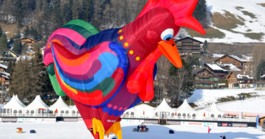CHATEAU D OEX, SWITZERLAND - JANUARY 27: International hot air balloon festival, balloon in the shape of a giant cock at the Balloon Festival January 27, 2010 in Chateau d'Oex Switzerland