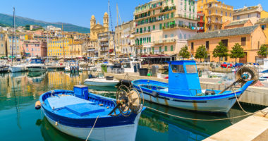 Traditional fishing boats in Bastia port on sunny summer day, Corsica island, France