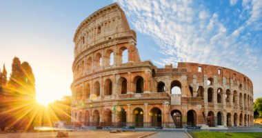 Panoramic view of Colosseum in Rome and morning sun, Italy, Europe.