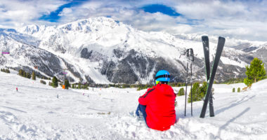 Young skier enjoying the view in Swiss Alps