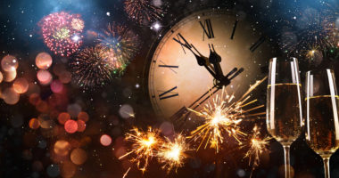 New Years Eve celebration background. Toast with fireworks and champagne at midnight
