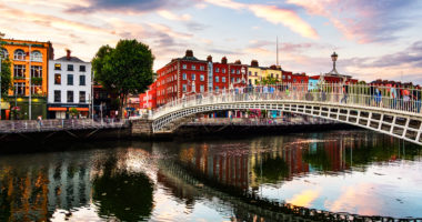 Dublin, Ireland. Night view of famous illuminated Ha Penny Bridge in Dublin, Ireland at sunset