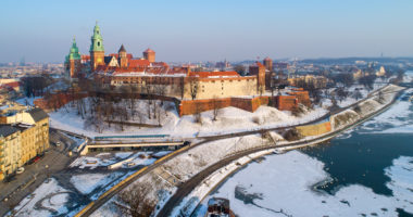 Wawel Castle, Cathedral and partly frozen Vistula river in winter. Krakow, Poland. Aerial skyline in sunset light