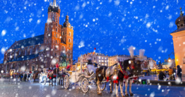 Old town of Krakow on a cold winter night with falling snow, Poland
