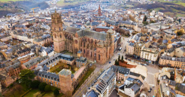 Aerial view of residential houses and ancient historical buildings of French city of Rodez in winter day