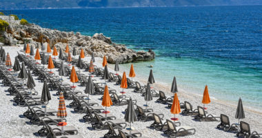 empty stone beach with sunshades in Rabac Croatia may 2019