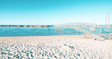 Intentionally overexposed shot of the beach of Bellaria Igea Marina, in the riviera Romagnola area on the Adriatic coast. Usually crowded, now deserted due to social distancing and sanitary emegency