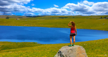 woman tourist looking at the lake, aubrac, laguiole, aveyron