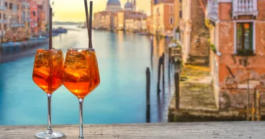 two Aperol Spritz in Venice, in the background the view from the Accademia Bridge