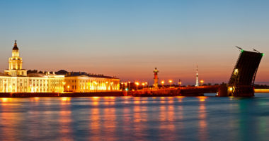 Panorama of quays of St.-Petersburg and the raised bridge at white night