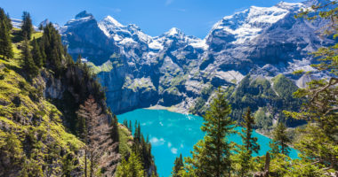 The panorama in summer view over the Oeschinensee (Oeschinen lake) and the alps on the other side near Kandersteg on bernese oberland in Switzerland.