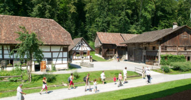 Ballenberg, Switzerland - 14 July 2005: People visiting on walking old farm houses in Ballenberg, a Swiss open-air museum in Brienz, Switzerland Ballenberg, Switzerland - 14 July 2005: People visiting on walking old farm houses in Ballenberg, a Swiss open-air museum in Brienz, Switzerland